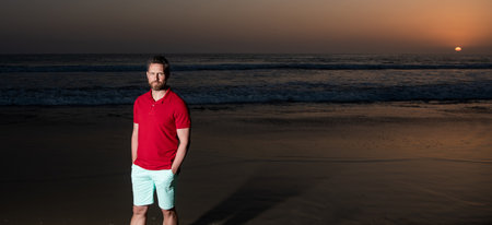 handsome man over the sea on sunset summer beach, copy space, summerの写真素材