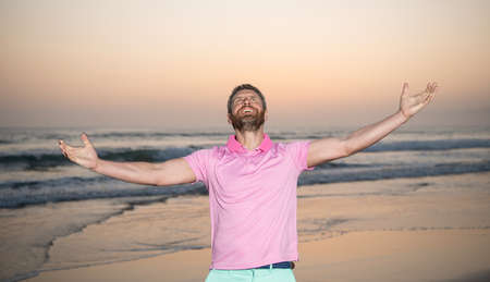 happy man over the sea feel freedom on morning summer beach, vacationの写真素材