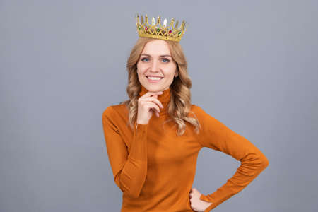 portrait of glory. smiling blonde woman in crown. self confident queen. expressing smugの写真素材