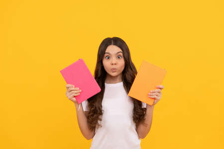 amazed school kid ready to study choose notebook, knowledgeの写真素材