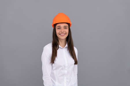 cheerful woman in safety hardhat and white shirt, businesswomanの写真素材