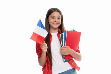 happy teen girl hold french flag and school copybook for studying, education abroad.の写真素材