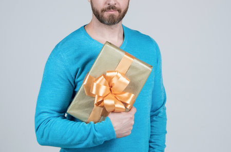 prepare in advance. cropped guy giving birthday gift. man hold box. copy space. concept of shopping.の写真素材