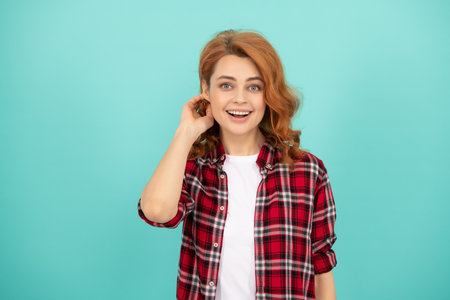happy redhead woman with curly hair in checkered casual shirt, styleの写真素材