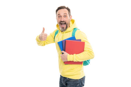 mature happy man carry backpack and notebook. smiling senior guy back to school isolated on whiteの写真素材