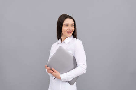 happy woman in white shirt hold computer, new technologyの写真素材