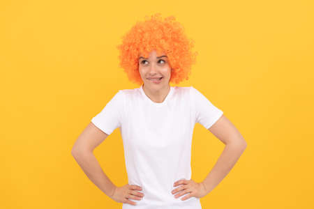 dreamy freaky woman in curly clown wig imagine something, imaginationの写真素材