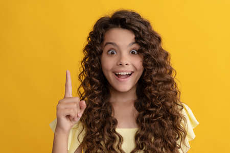 female fashion model inspired with idea. teen beauty. frizzy hair curl. girl has wavy hairdo.の写真素材