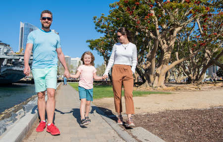 happy young family walking in park with son, familyの写真素材