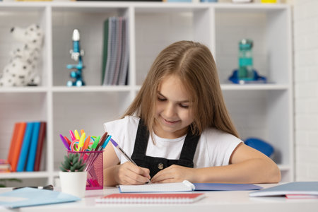 happy kid write in workbook at school lesson in classroom wear uniform, knowledgeの写真素材