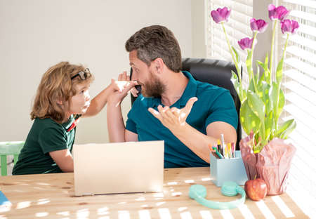 mature man teacher or dad helping kid son with school homework on computer, parenthoodの写真素材