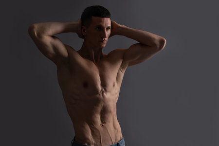 Shirtless and bare-chested. Shirtless man grey background. Fit guy with muscular torsoの写真素材