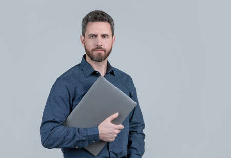Virtually connected. Unshaven man hold laptop. Online courses. Online ccommunicationの写真素材