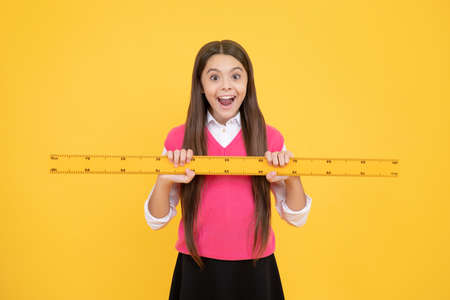 surprised kid girl use ruler to learn mathematics, measurementの写真素材