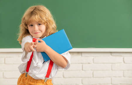 happy teen boy in classroom. back to school. knowledge day. concept of education.の写真素材