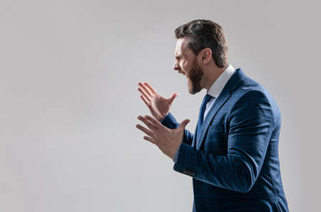 Distressful experience. Angry boss scream making wide gesture. Professional man scream in angerの写真素材