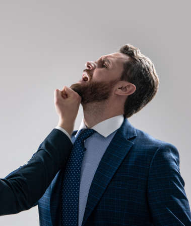 Got punched in face. Professional man punched by colleague. Fighting and conflicting. Punchingの写真素材