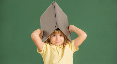 kid boy study online in school classrrom with laptop, education