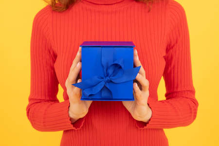 Woman cropped view hold blue gift box with ribbon bow decoration holiday celebration, present.の写真素材