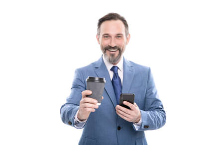 happy mature ceo in suit chatting on phone and drink coffee isolated on white, coffee breakの写真素材