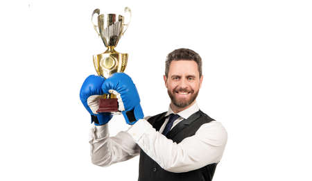 happy guy in boxing gloves and formalwear hold champion cup isolated on white background, victoryの写真素材