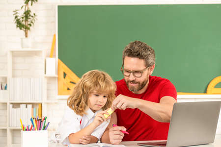 father and child study in classroom with laptop, knowledge