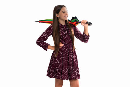 kid with rainbow umbrella isolated on white. autumn season. rainy weather forecast.の写真素材