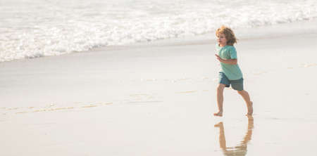 sport child run fast to win in the ocean. morning workout activity. healthy kid running on beachの写真素材
