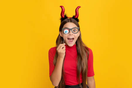 teen girl on yellow background. celebrate autumn party holiday. childhood fun.の写真素材