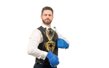 boss show victory and authority. businessman in boxing gloves with trophy.の写真素材