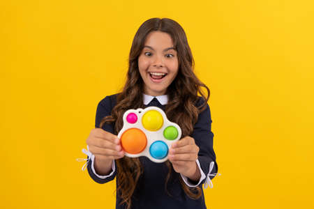 amazed child showing simple dimple popit fidget. antistress silicone toy. sensory fidgeting.の写真素材