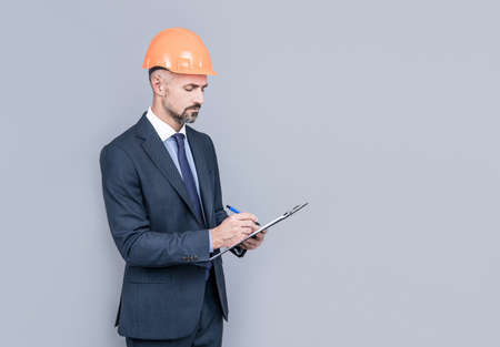 safety business expertise. successful man in hardhat making notes. entrepreneur read project.の写真素材