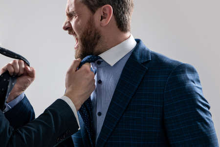 Angry man businessman scream pulling and being pulled by necktie during physical fight, fighting