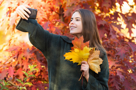 autumn nature. beautiful face portrait. natural beauty. fall season fashion. girl making selfie