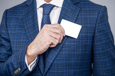 Card for presenting contact information in male hand formalwear cropped view, business, copy space