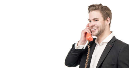 Happy man call center operator is on corded old-fashioned vintage telephone, retro connection