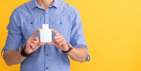 cropped man hold jar with medicine pills. drug business. man take meds. medical advertisement.