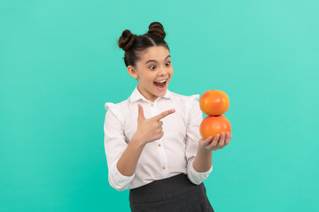 amazed child eating healthy food. childhood health. citrus fruits.