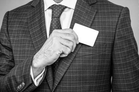 Card for presenting contact information in male hand formalwear cropped view, business, copy spaceの写真素材