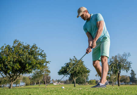 summer activity. professional sport outdoor. male golf player on professional golf course.の写真素材