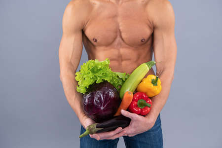 Eat like athlete. Athletic man cropped view hold vegetables. Sports nutrition. Be nutrition wealthyの写真素材