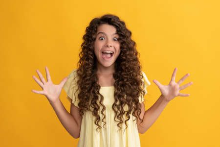 haircare and skincare. hairdresser. shocked kid with curly hair. teen beauty hairstyle.の写真素材