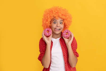 food and dessert. donut bakery. teen girl having fun. baked goods. sweet tooth.の写真素材