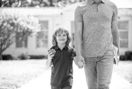 happy child with apple hold cropped fathers hand or teacher coming back from school, childhoodの写真素材