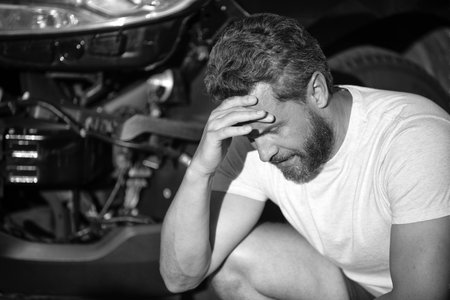 upset driver after traffic accident. man with auto broken on road. car insurance.の写真素材