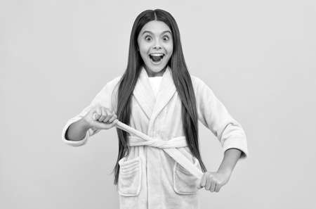 amazed teen girl in home terry bathrobe, homewearの写真素材