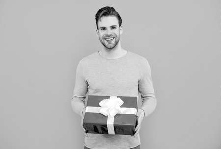 Making present. Happy guy hold present boxの写真素材
