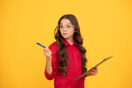 serious kid girl in eyeglasses hold paper folder, schoolの写真素材