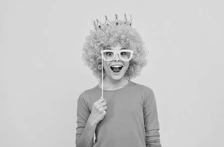 wow. funny child in party glasses. selfish teen girl in tiara. pageant. april fools day.の写真素材