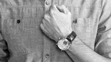 showing wristwatch. you are late. deadline. time management. mens wardrobe.の写真素材